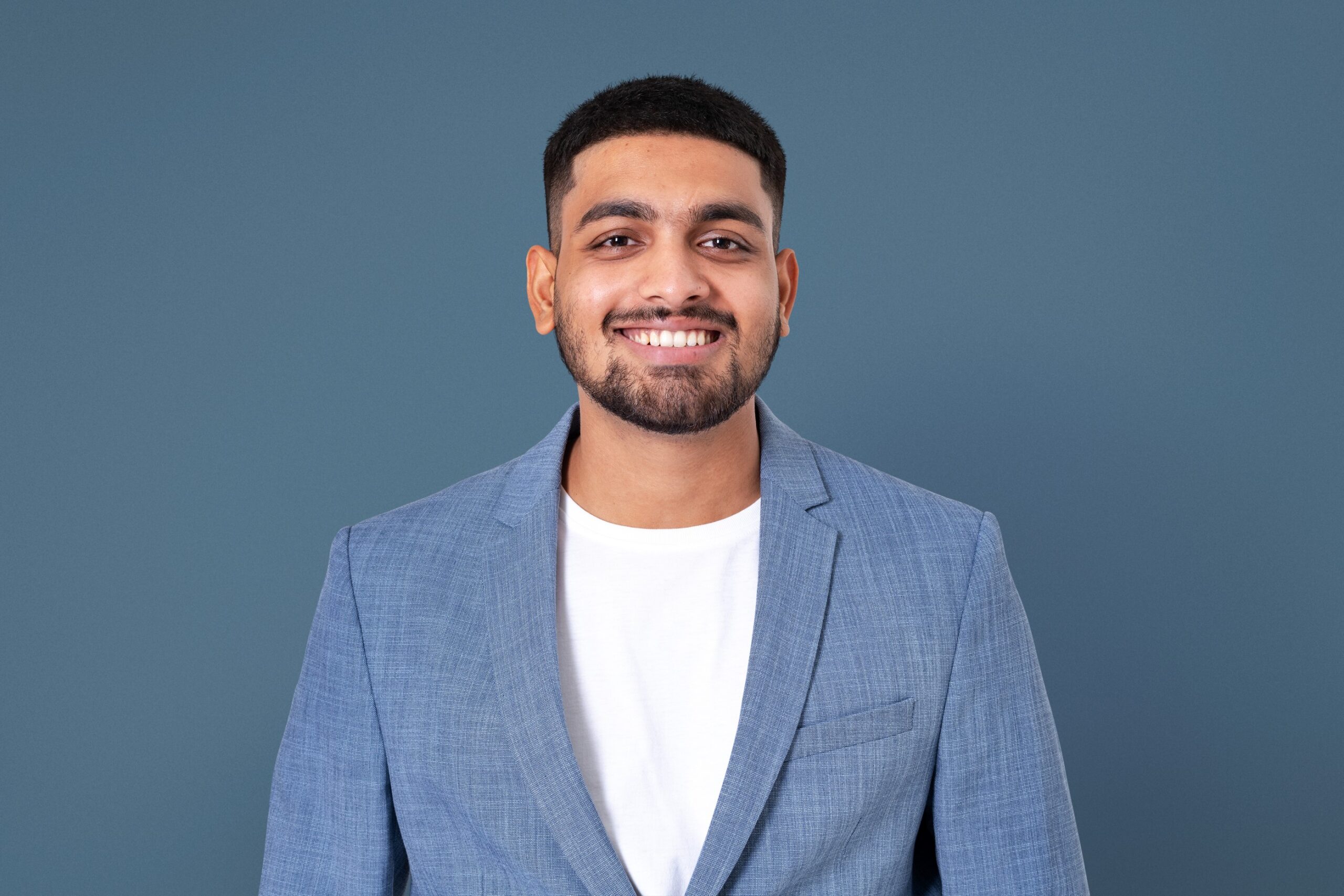 cheerful indian businessman smiling closeup portrait jobs career campaign 1 scaled